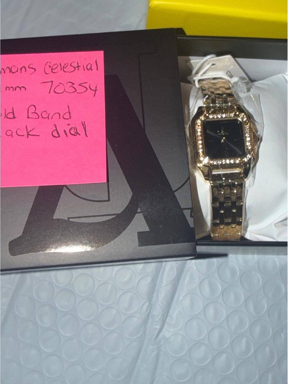 $249 WOMANS CELESTIAL WATCH GOLD BAND/BLACK FACE WITH CRYSTAL BEZEL